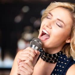 Singer hitting high notes by switching her voice from chest voice to head voice.