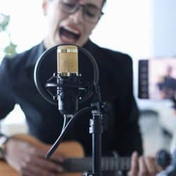 Singer recording singing performance for Youtube.